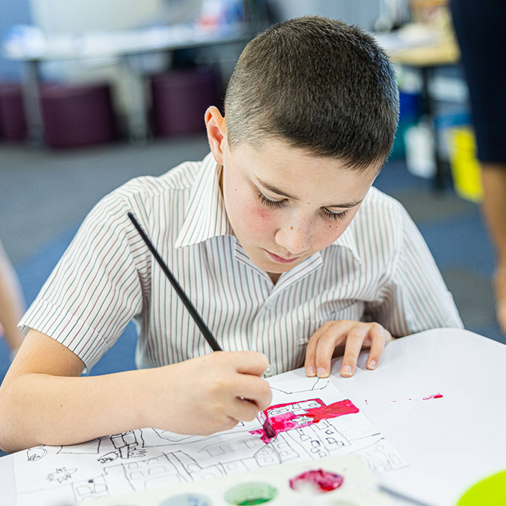 Boy paining at Holy Spirit Catholic Primary St Clair